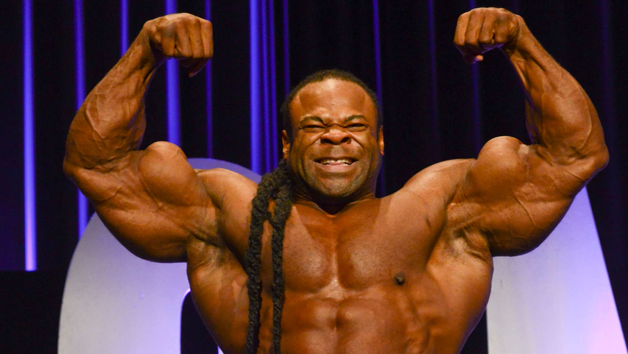 Kai Greene flexing his arms during a bodybuilding appearance
