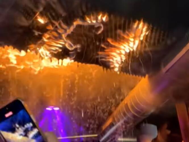 Leute in Bar tanzen und filmen statt zu flüchten